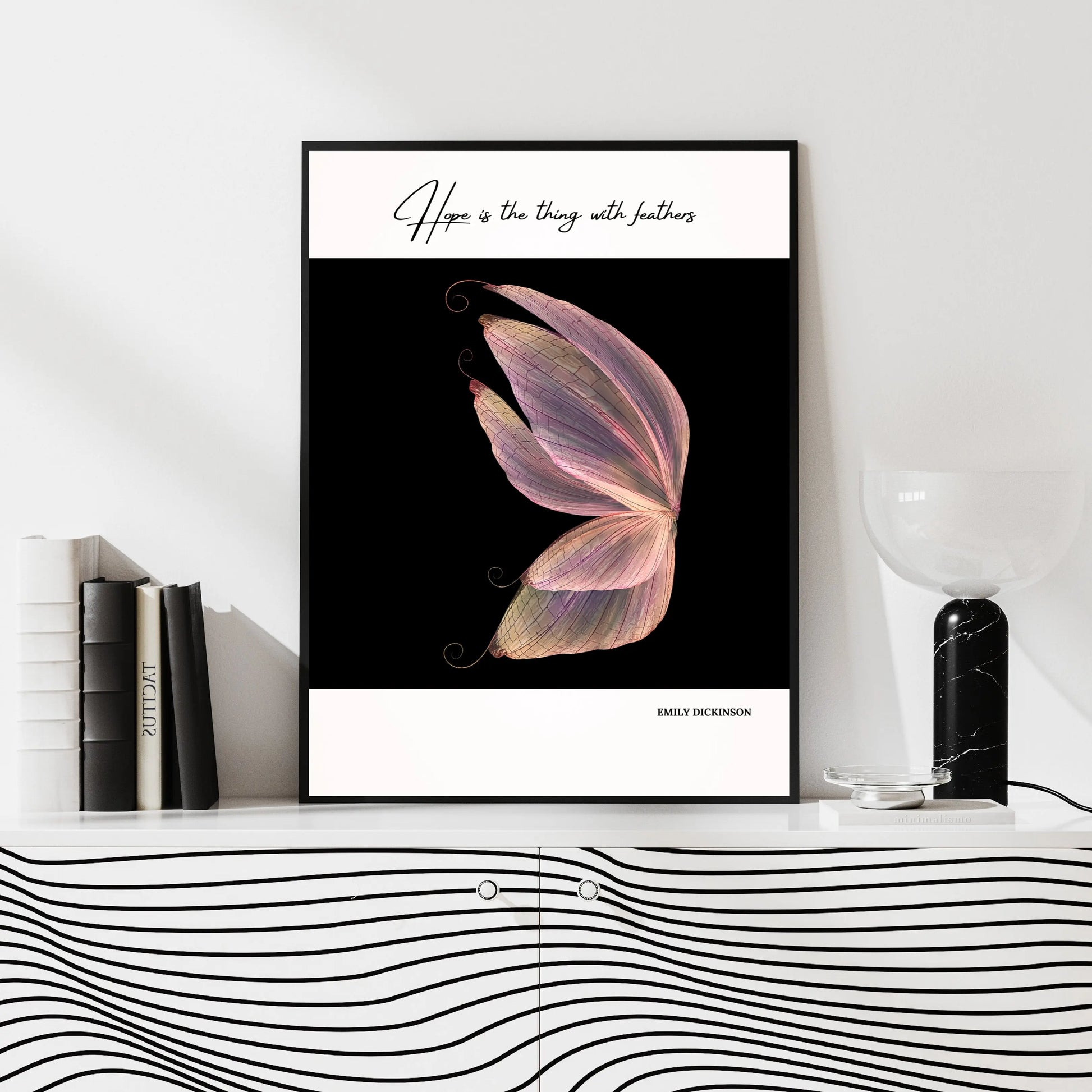 A poster featuring a quote by Emily Dickinson, 'Hope is the thing with feathers,' with an image of a butterfly wing in pastel colors on a black background.