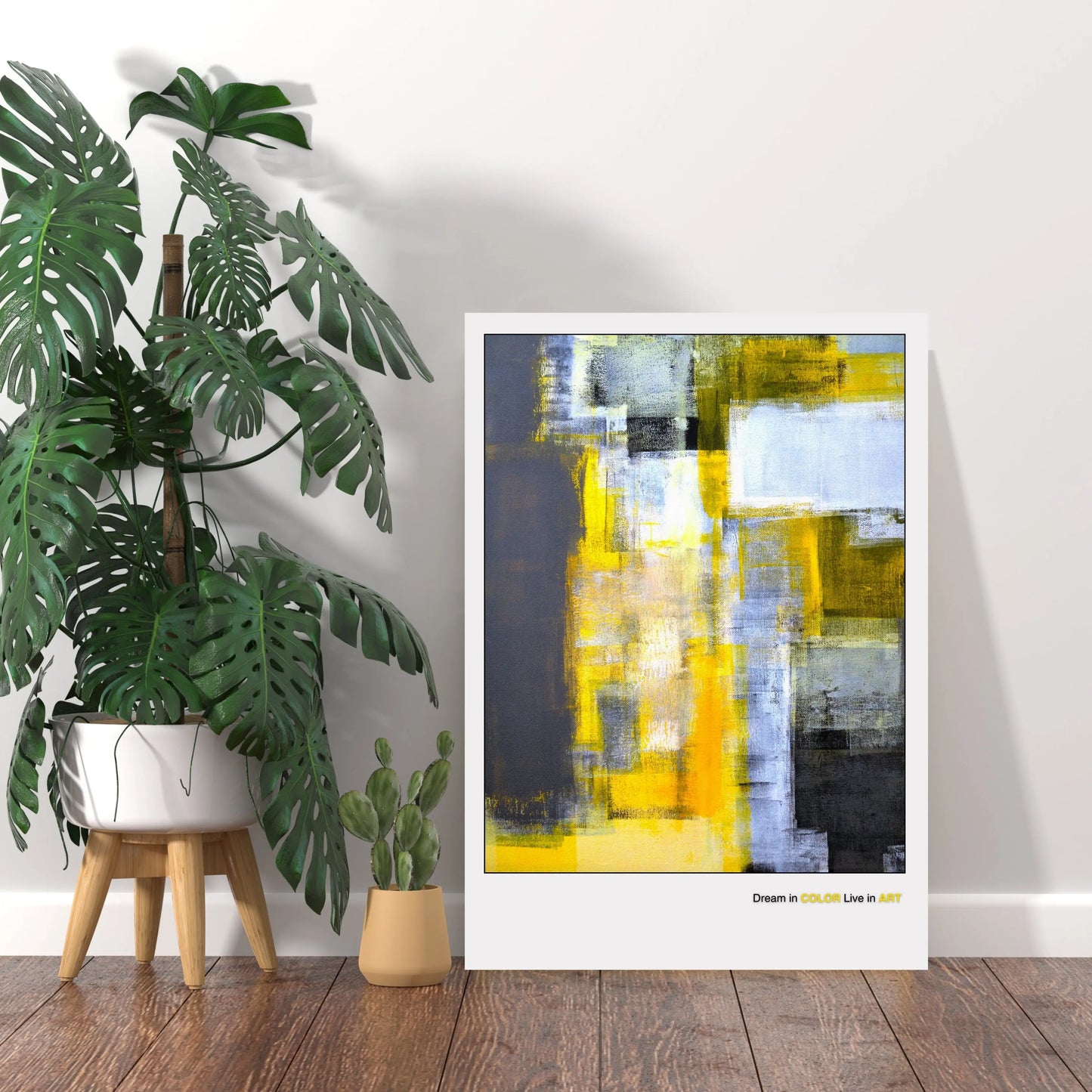 An abstract fine art poster featuring geometric shapes in yellow, gray, and black colors with the phrase 'Dream in COLOR Live in ART' at the bottom.